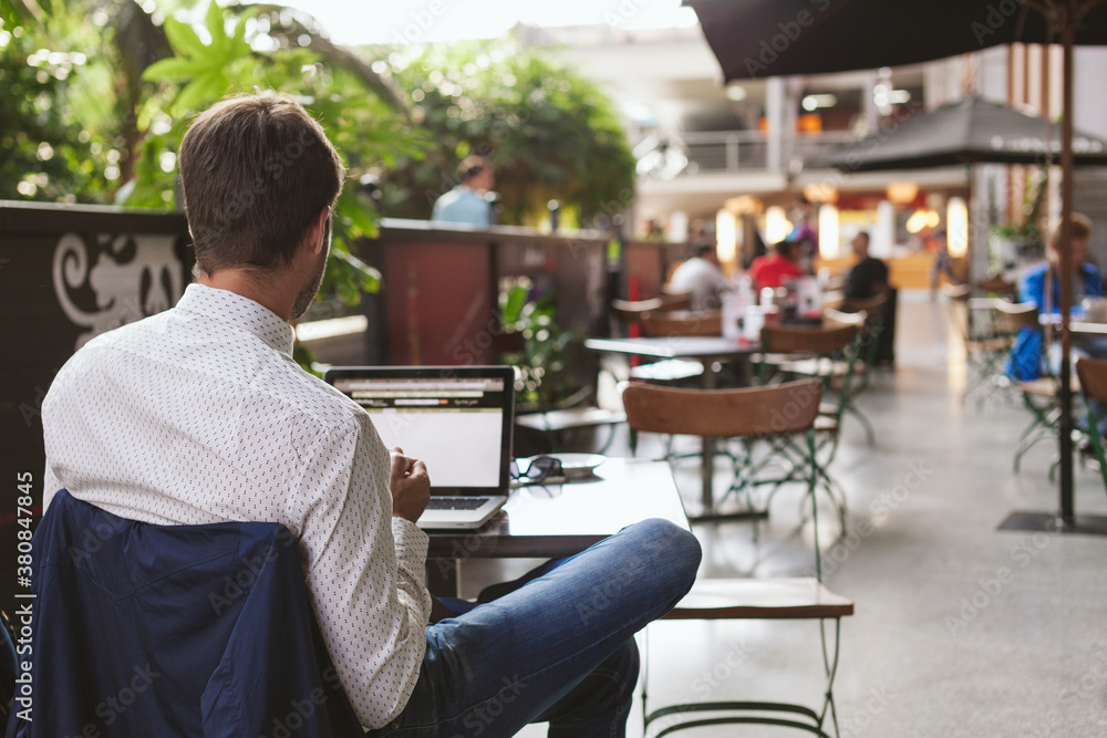 Elegant Young Businessman Working in a Coffee Shop Elegant Young Businessman Working in a Coffee Shop