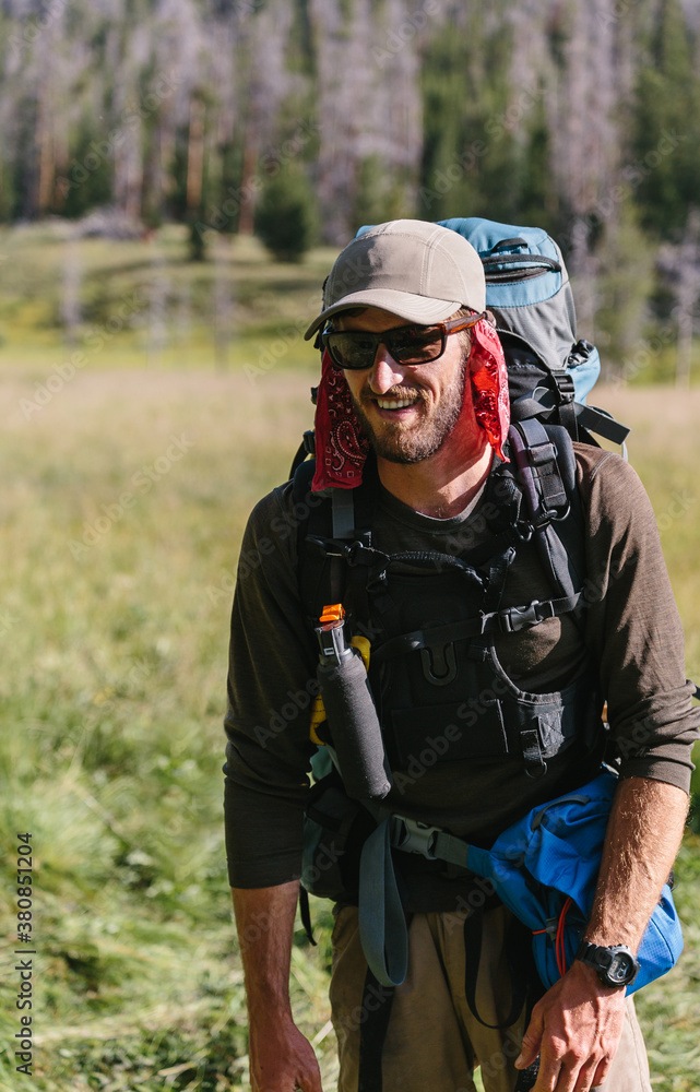 Happy man prepared for backpacking adventure Happy man prepared for backpacking adventure
