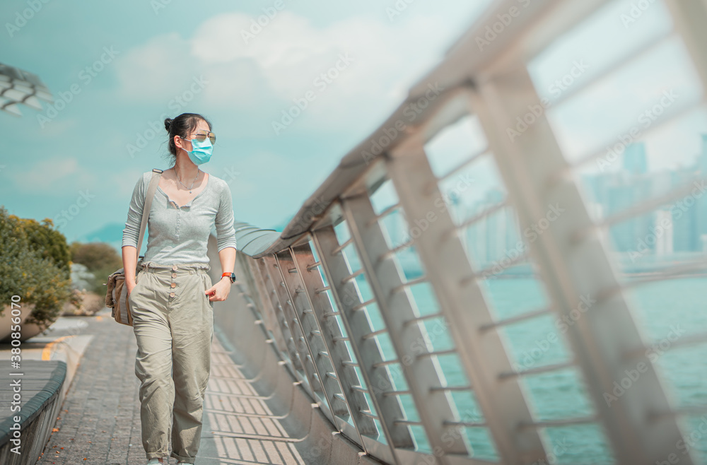 Woman wearing mask traveling  in Hong Kong