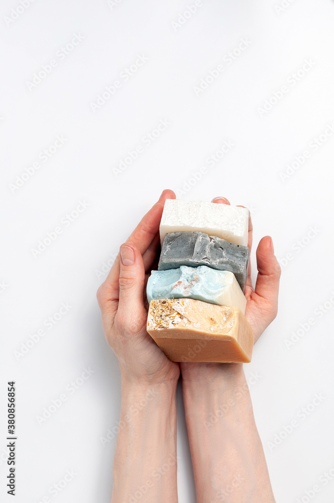 Woman holding natural handmade soap bar on white background