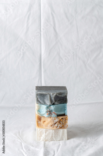 Obraz na płótnie Four types of natural handmade soap bar on white cloth background w salonie