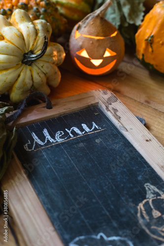 Tray decorated for Halloween with pumpkins, dry grapevine leaves and chalkboard menu photo