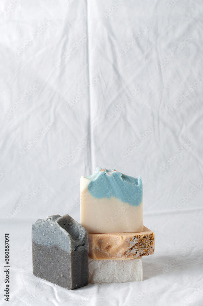 Four types of natural handmade soap bar on white cloth background