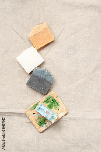 Obraz na płótnie Natural handmade soap bar in ceramic soap dish on linen fabric background w salonie
