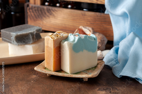 Obraz na płótnie Natural handmade soap bar in ceramic soap dish with spa accessories on wooden table w salonie