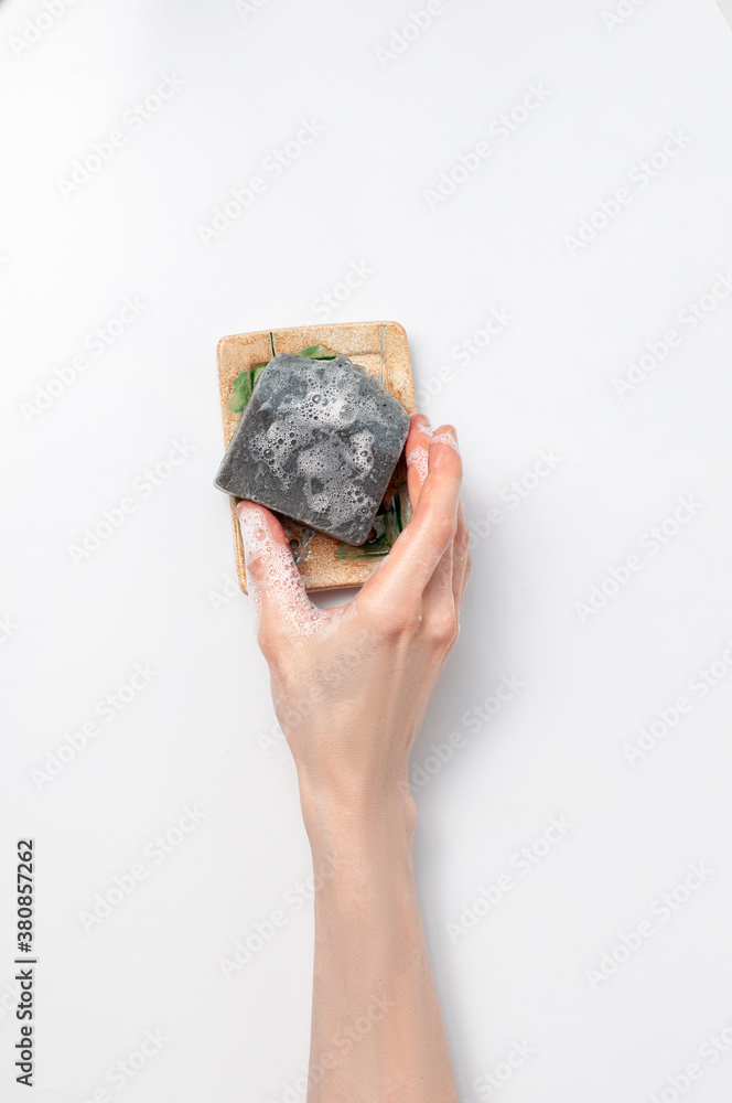 Woman holding natural handmade soap bar on white background