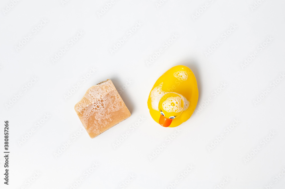 Natural handmade soap bar with rubber duck on white table