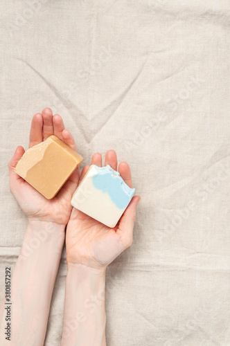 Obraz na płótnie Woman holding natural handmade soap bar on linen fabric background w salonie