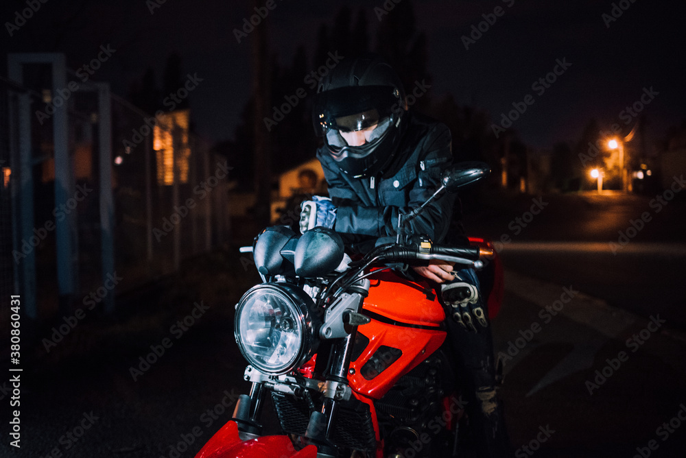 Portrait of biker sitting on his bike with helmet Portrait of biker sitting on his bike with helmet