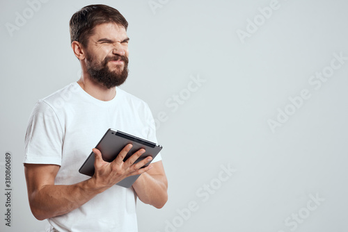 emotional man with tablet in hand touch screen new technologies light background cropped view Copy Space