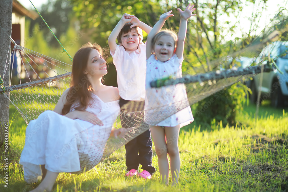 Fototapeta premium The family is resting in nature. Vacations in the fresh air. Weekend children play in the park.