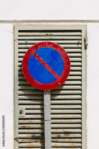 No Parking Sign on a Metallic Gate photo