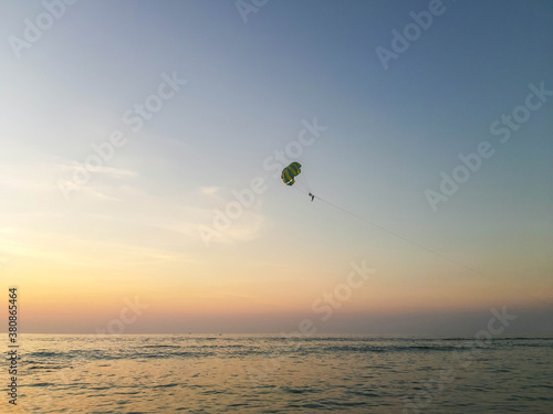 Parachute flight over the Andaman Sea in Thailand on a warm evening.