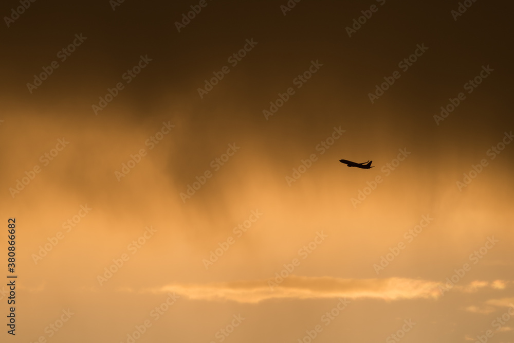 Commercial flight taking off at sunset Commercial flight taking off at sunset