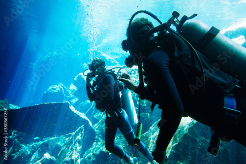 Wallpaper Mural Two scuba divers communicating by signs while diving in clear water of a cenote in YucatÔøΩÔøΩn, Mexico Torontodigital.ca