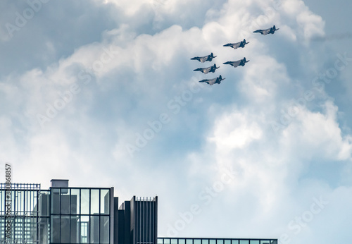 Photography Singapore Air Force F15 fighter jets flying over the city above residential condominium buildings