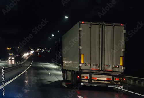 Truck moves on highway at night