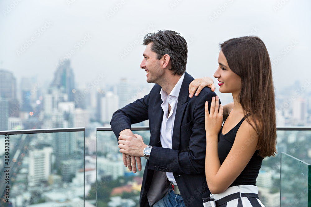 Handsome young couple enjoying the view of a busy metropolis