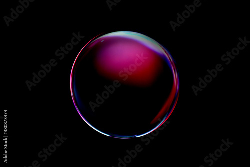 Blurry image of a shiny crystal ball with abstract blurry colorful pattern. Abstract lensball in blur.