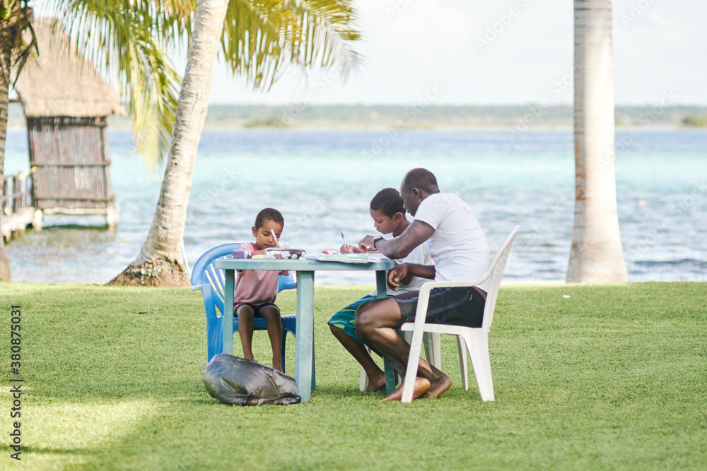 Father is home schooling his sons on tropical vacation Father is home schooling his sons on tropical vacation
