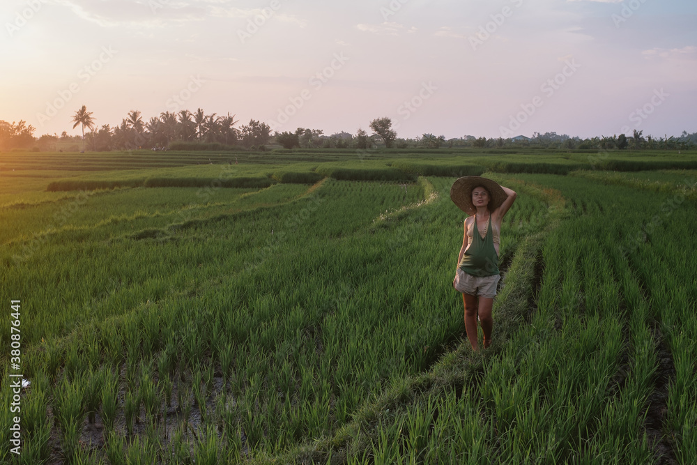 Woman Walking at Sunset In A Green Field Woman Walking at Sunset In A Green Field