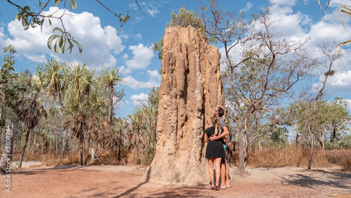 Couple looking at Termite mound in national park photo