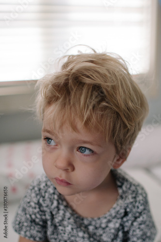 Little blonde girl who has just woken up. photo