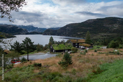 Traditional norwegian wooden houses with grass on the roof