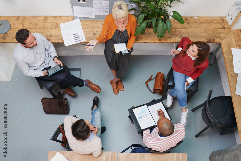 © Aila Images/Stocksy - Group of business people having meeting