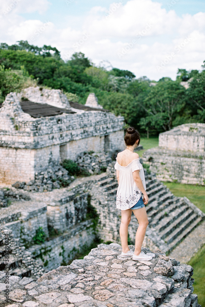 Woman standing overlooking ruins Woman standing overlooking ruins