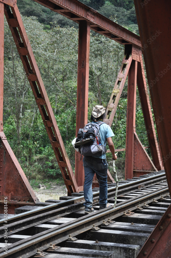 Hikers walking alongside the railroad tracks that lead to Aguas Calientes, the gateway to Machu Picchu, in Peru