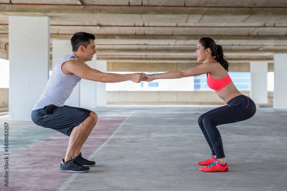 A couple working out together in an urban environment A couple working out together in an urban environment