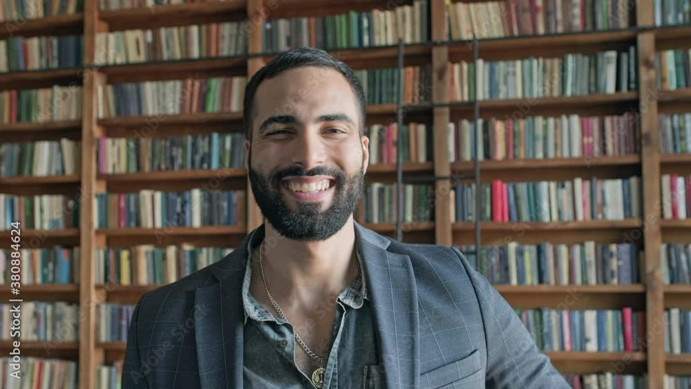 Stylish Guy In The Library Shows With His Hand That Everything Is Fine. Stylish Guy In The Library Shows With His Hand That Everything Is Fine.