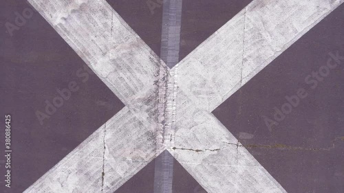 Drone overhead shot of letter X painted on a runway. Slow rise to reveal X on the runway. 4K inspire 2 footage shot with X5S camera with a 15mm lens. photo