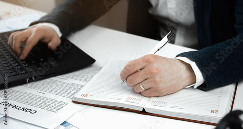 Cropped view of businessman works with financial papers at the table. Finance concept