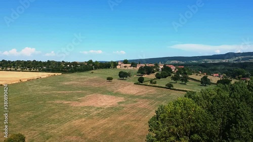 Slow forwards moving drone shot of wheat fields, near small village Taize in France. photo