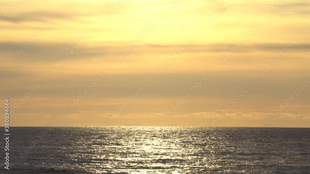 Peaceful shimmering sea against lowering sun and beautiful sky. Peaceful shimmering sea against lowering sun and beautiful sky.