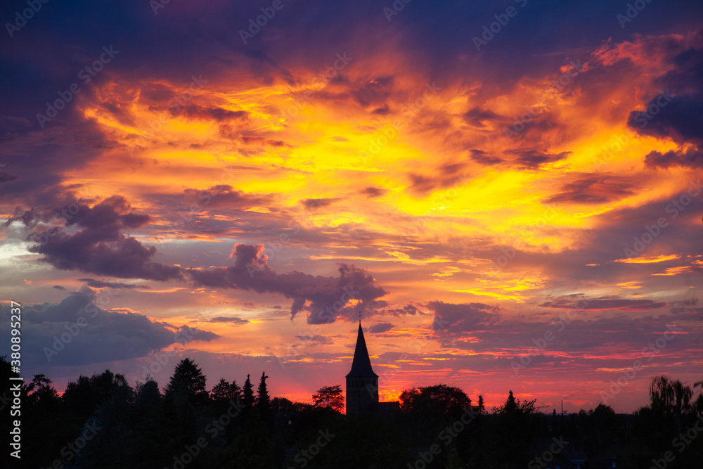 sunset over the church of ratingen homberg with colorful sky