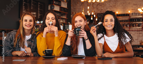 Crazy female friends hanging out at a cafe
