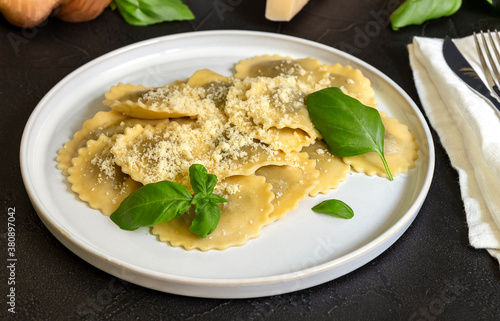 Cooked ravioli or tortelli with cheese, basil, and mushrooms.