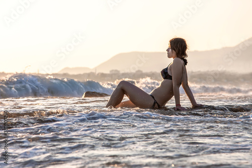 Girl sitting on a beautiful seashore