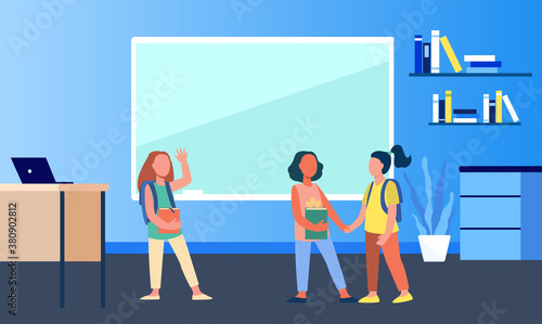 Schoolgirls meeting in classroom. Group of friends, classmates holding hands, waving hello flat vector illustration. Communication, friendship concept for banner, website design or landing web page