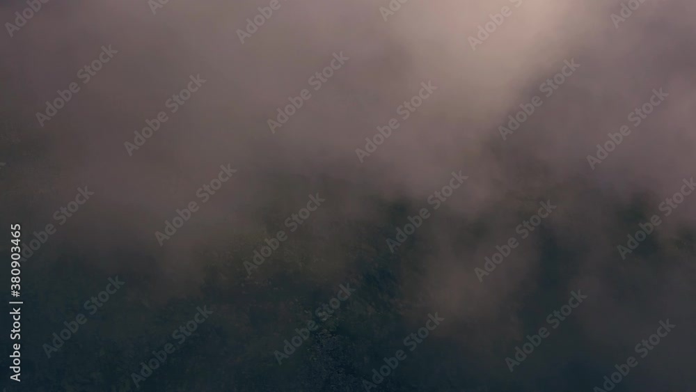 Wide shot of aerial drone view of Retezat Mountains, Romania seen through fog. Wide shot of aerial drone view of Retezat Mountains, Romania seen through fog.