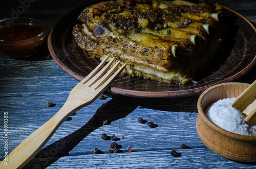 Still life with coocked pork ribs on the wooden desk photo