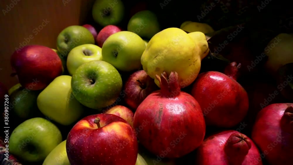 autumn harvest. apples, pomegranates and quince are in a wooden box. autumn harvest. apples, pomegranates and quince are in a wooden box.