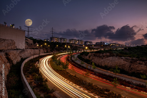 Rosh Haayin road with light trails and full moon photo