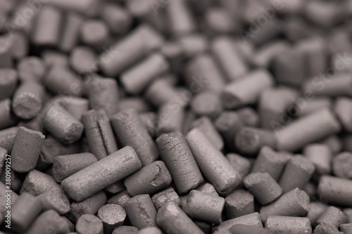 Activated carbon granules abstract background. Macro shot. Selective focus.