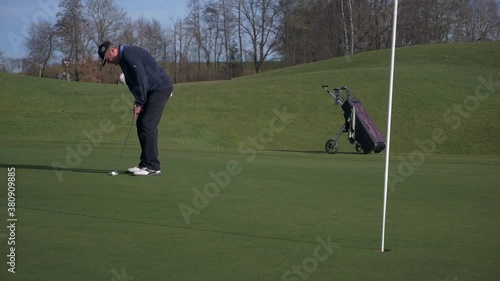 Golfer on Putting Green missing the Hole first than tapping in photo