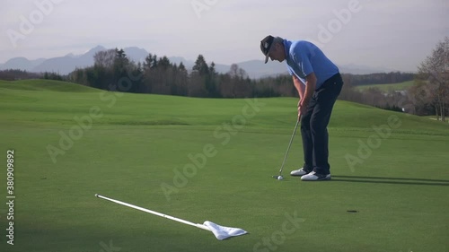 Golfer on Putting Green missing the Hole photo