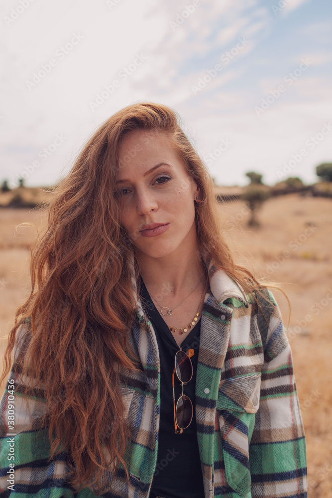 Portrait of a good-looking model looking to the camera with her hair to the side Portrait of a good-looking model looking to the camera with her hair to the side